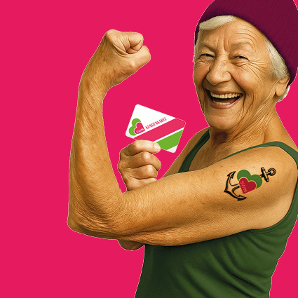 Ältere Frau zeigt lachend ihren Bizeps und hält eine Stadtwerke-Karte; daneben steht der Hinweis „Jura-Privatstrom – nur 28,963 ct/kWh“ auf pinkem Hintergrund.